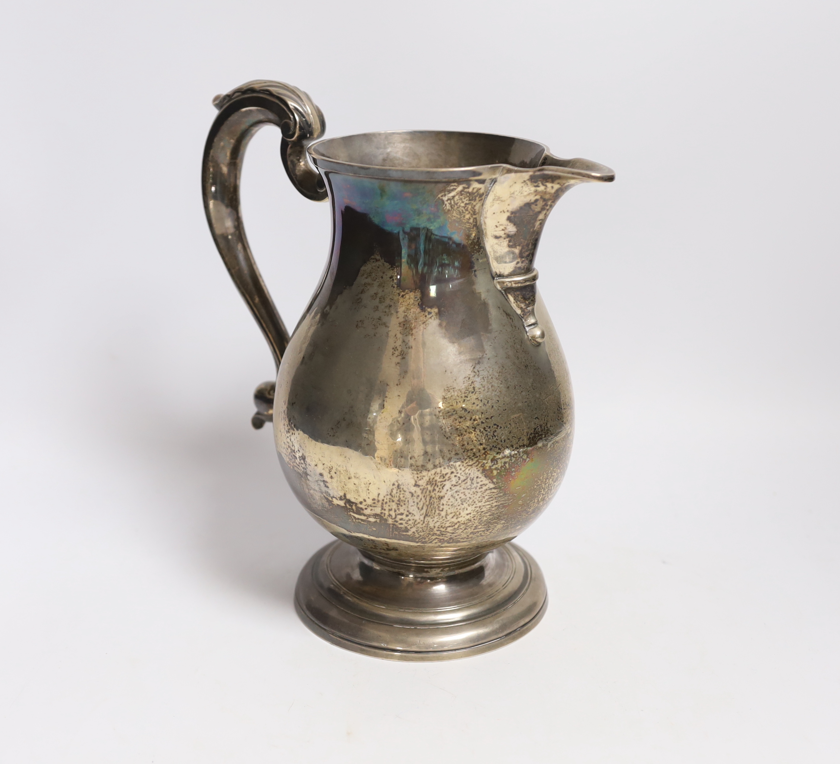 A George II silver baluster ale jug, on pedestal foot, Henry Brind, London, 1744, height 23.5cm, 33oz.
